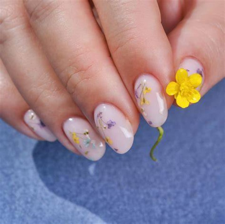 Botanical pressed flower nail art with real dried florals encapsulated in gel