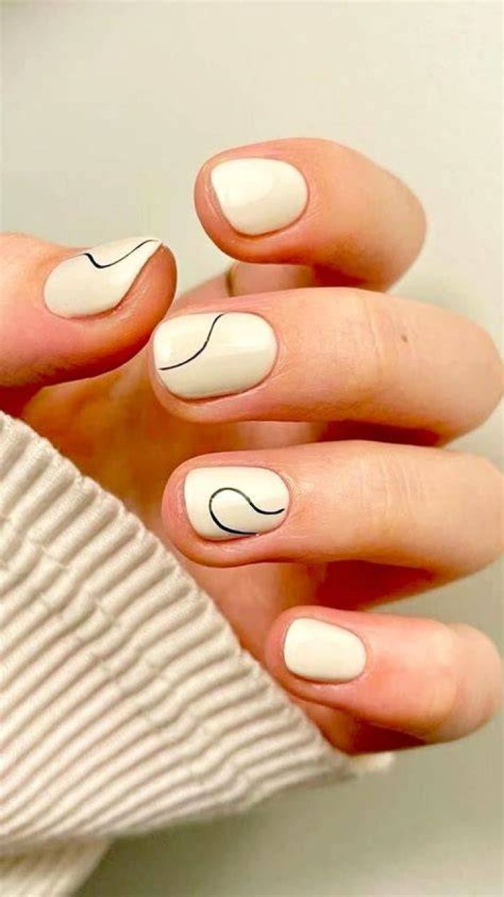 Negative space minimalist nail art design for 2026 with geometric cutouts